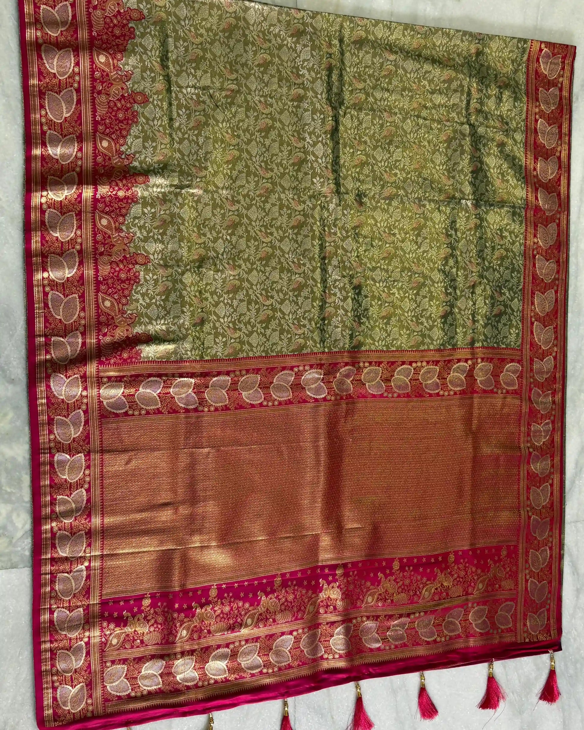 Traditional saree with green and red patterns on a white background