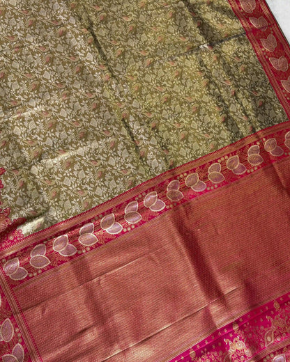 Close-up of a traditional saree with green and red patterns