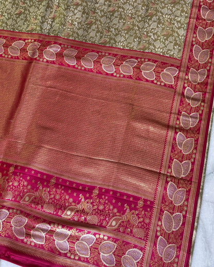 Traditional saree with pink and green patterns on a white background