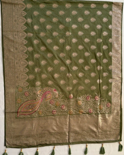 Green and beige embroidered fabric with tassels on a white background