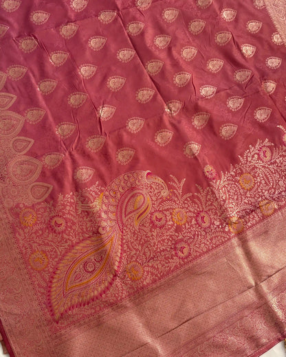 Pink fabric with intricate gold paisley patterns
