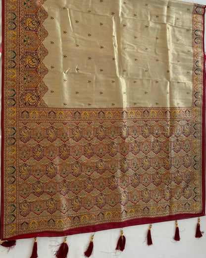 Decorative fabric with intricate patterns and tassels on a white background