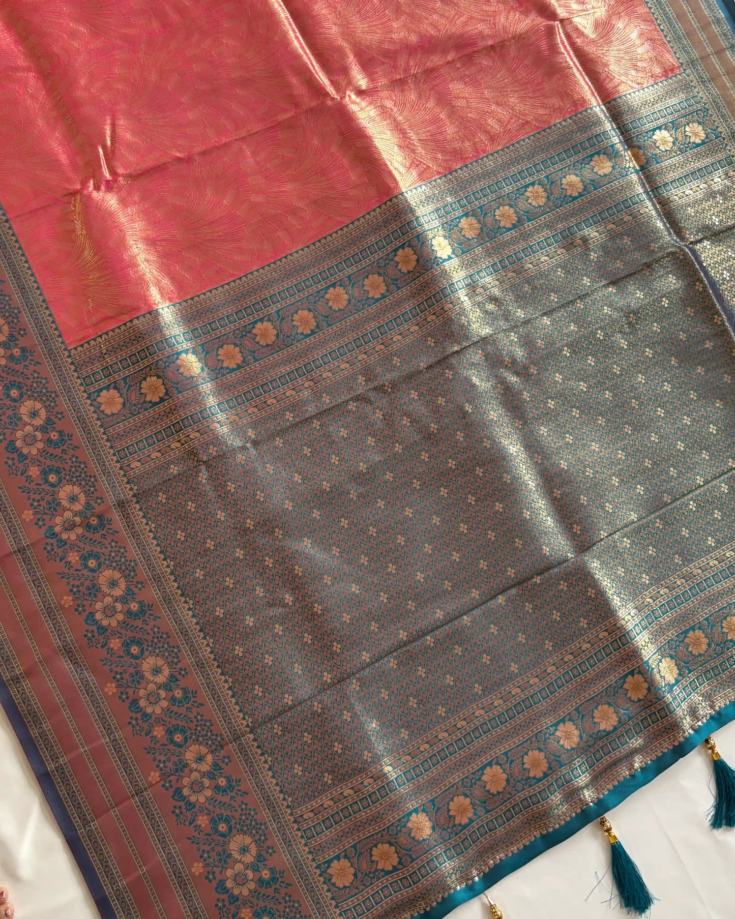Traditional saree with a red and blue patterned border on a white background