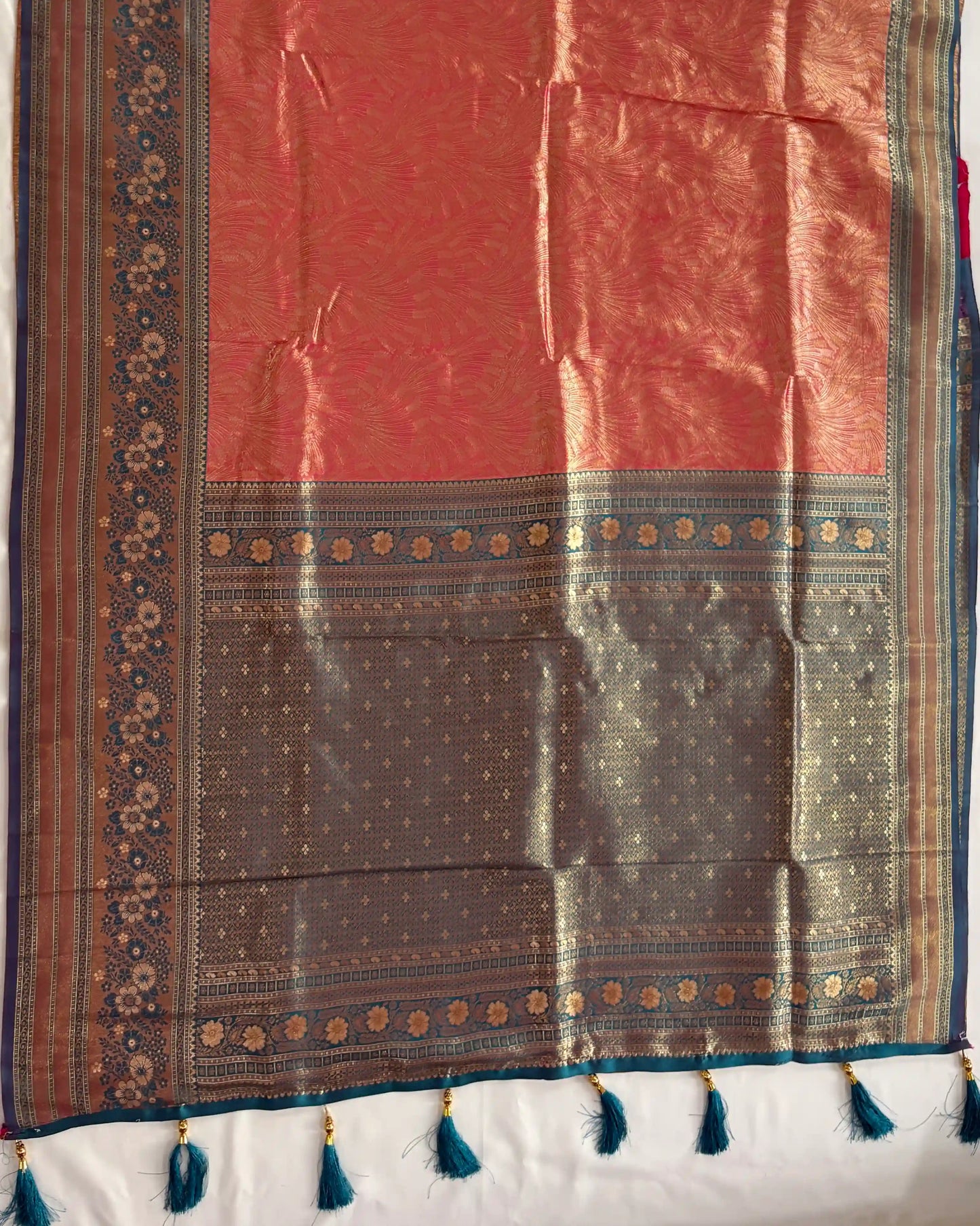 Traditional saree with a red and brown pattern on a white background