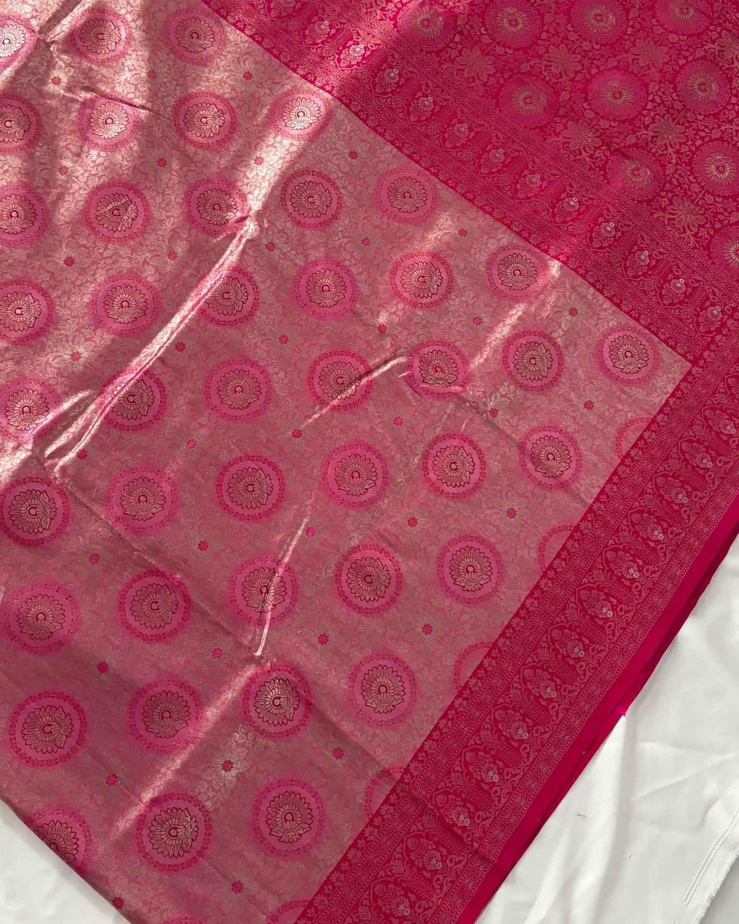 Pink fabric with circular patterns on a white background