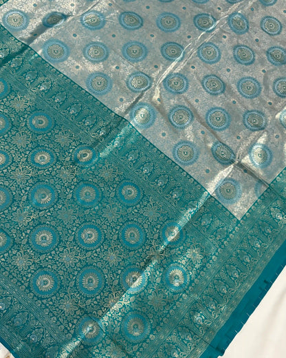 Teal fabric with circular patterns on a white background