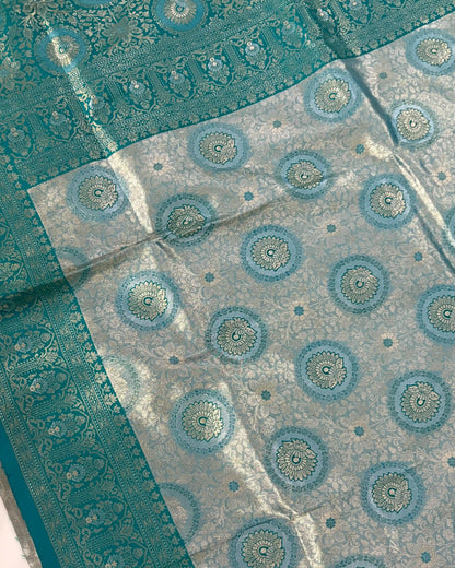 Teal and white patterned fabric with circular designs