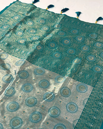 Teal and gray patterned fabric with tassels on a white background