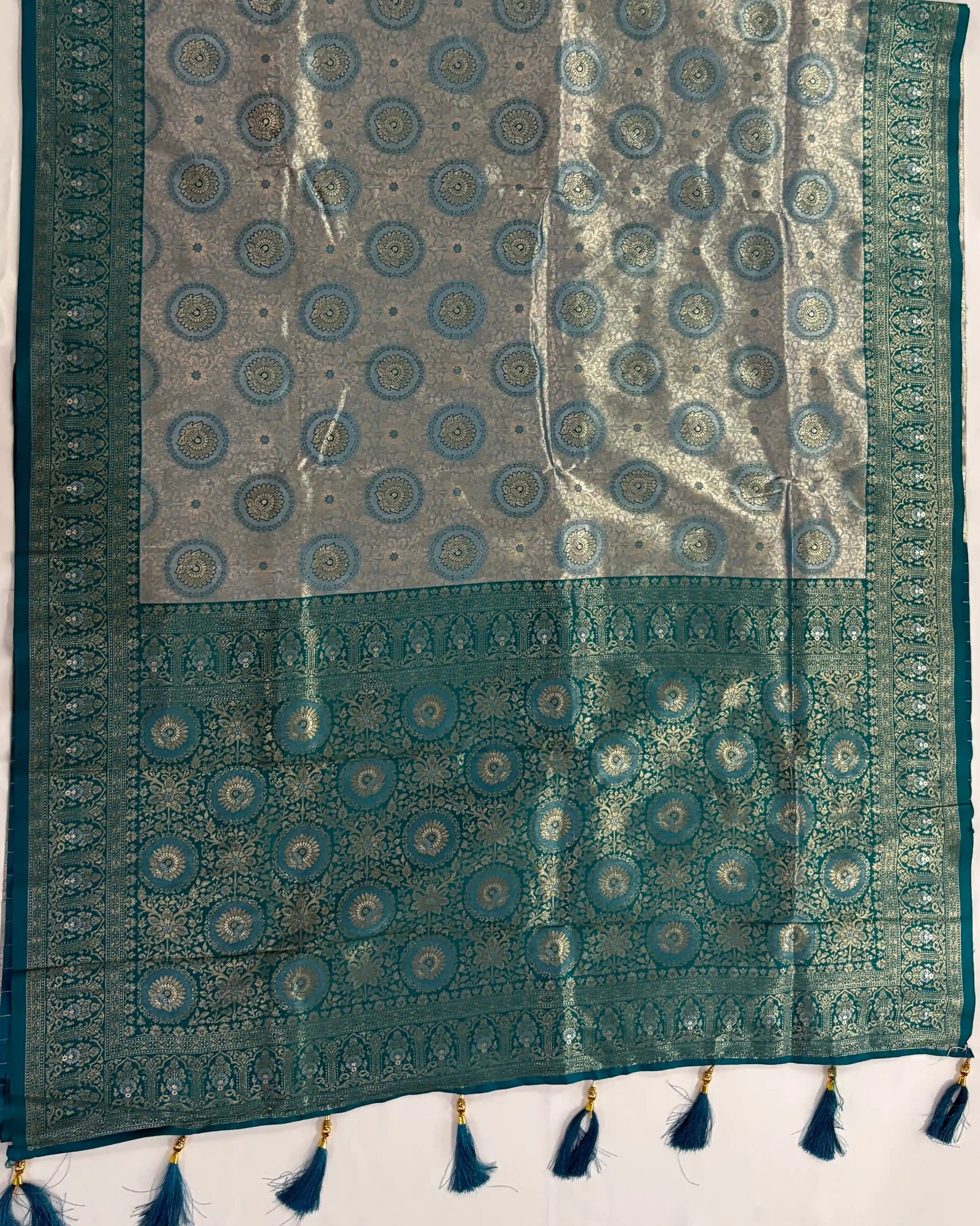 Traditional patterned fabric with tassels on a white background