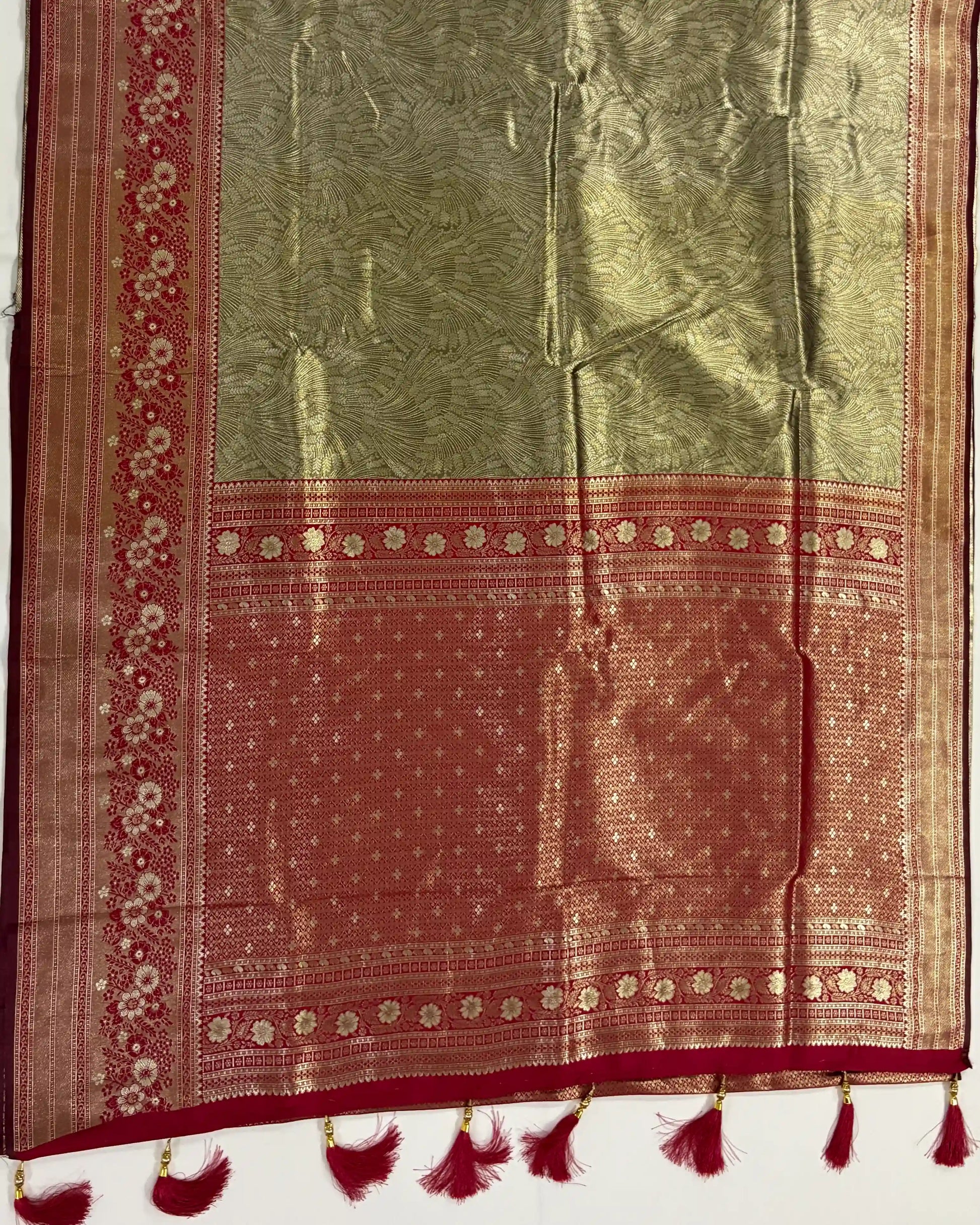 Traditional saree with red and green pattern on a white background