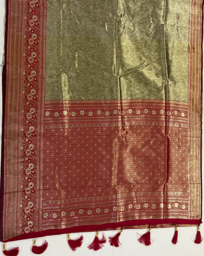Traditional saree with red and green pattern on a white background